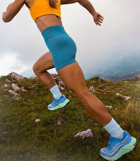 Merrell Shoes being worn by a person running in grass