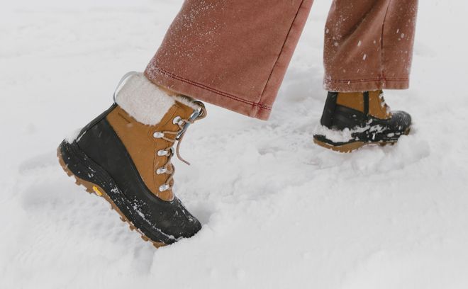 Women’s Merrell winter boots worn in the snow.