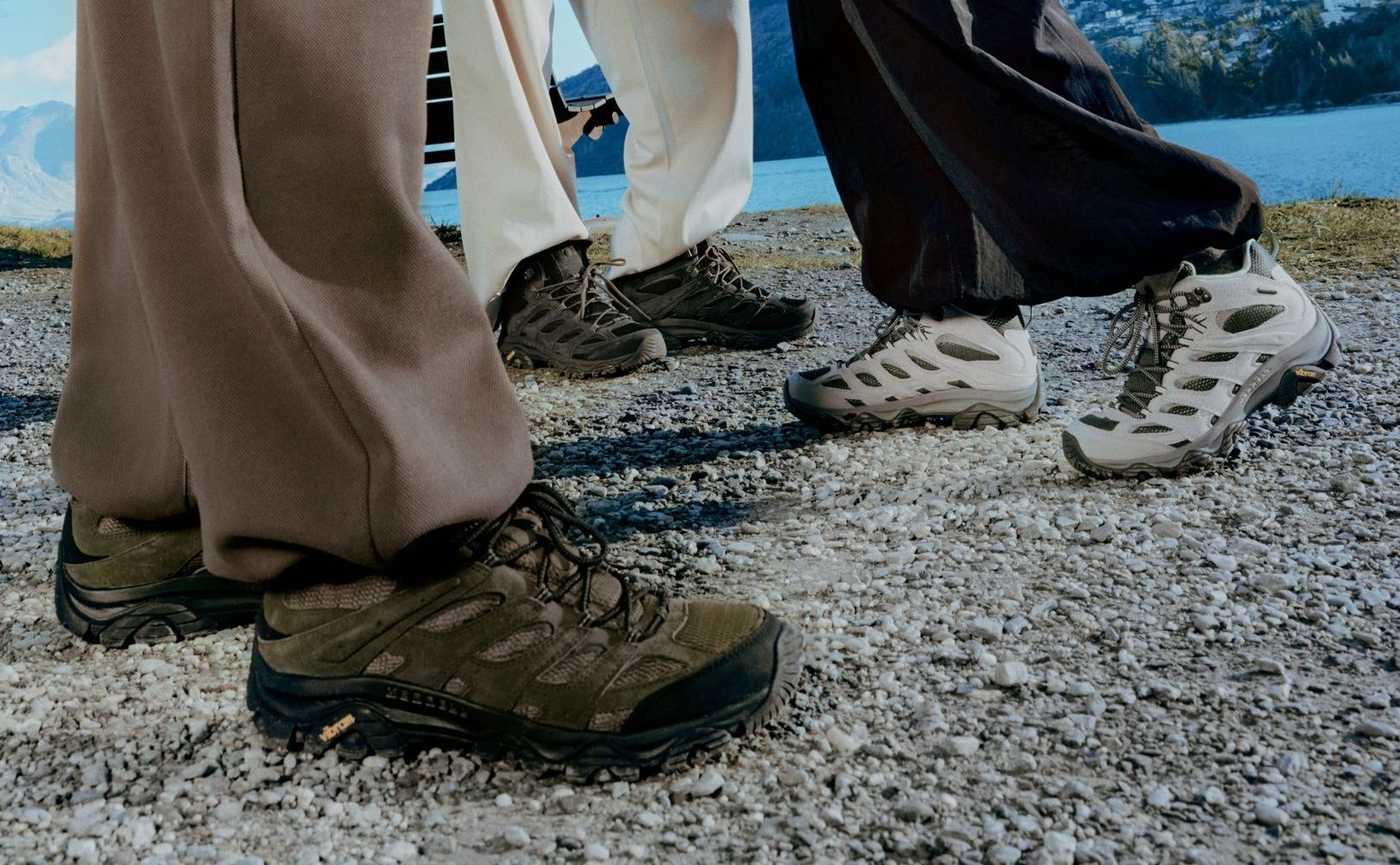 Hikers wearing Merrell shoes on a rocky trail.