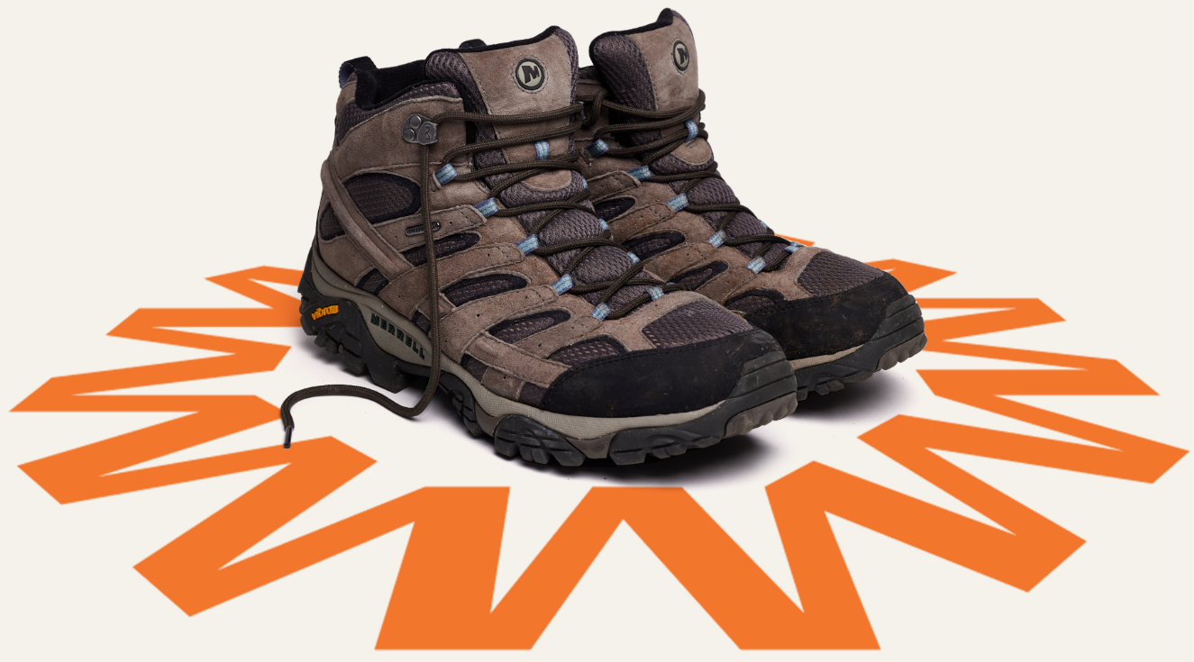 A pair of Merrell hiking boots surrounded a cool orange design.