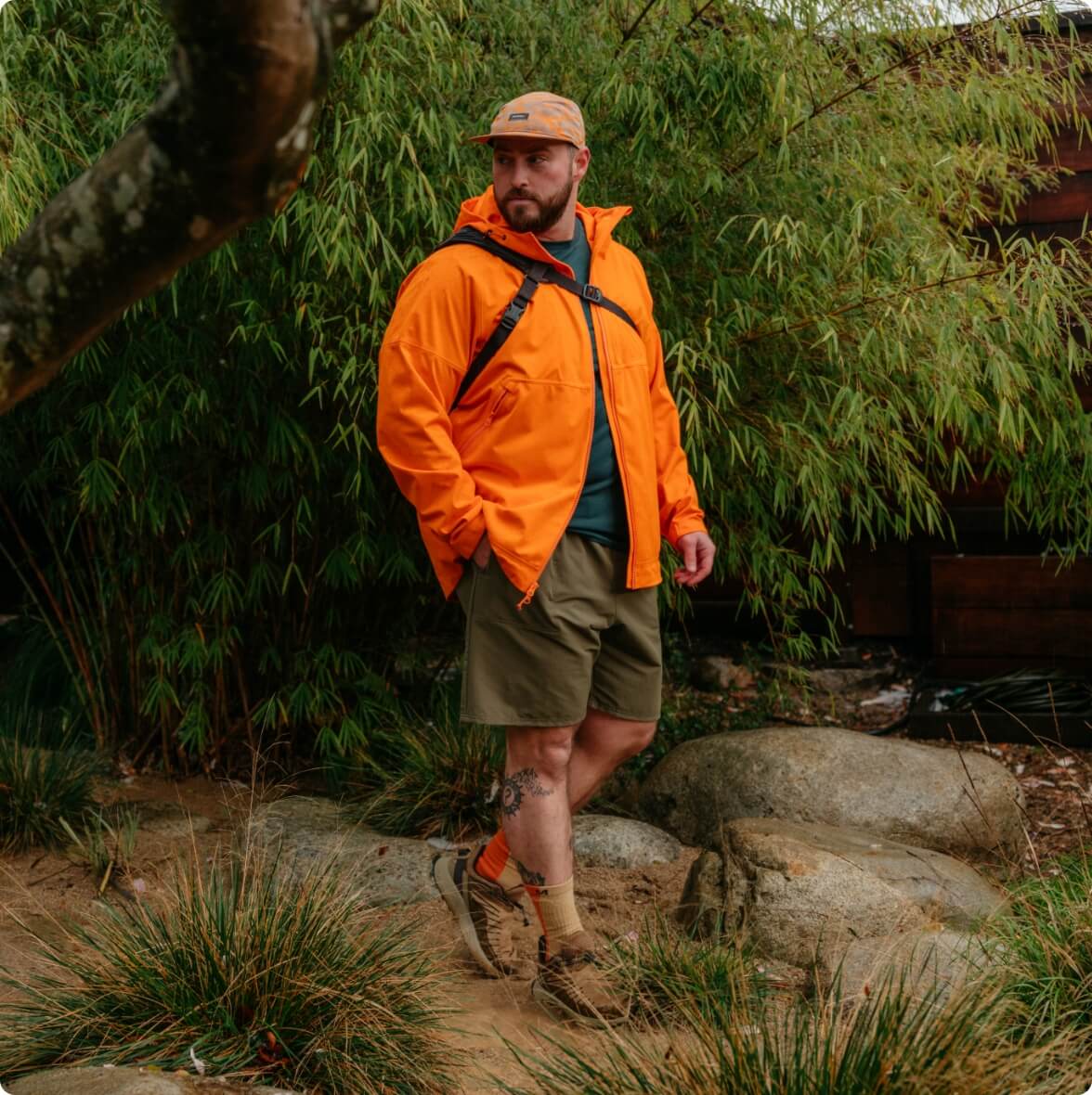 Person wearing orange rain jacket out in nature