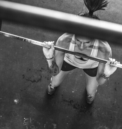 Looking down from directly above a person lifting a bar.