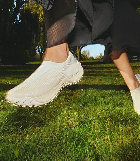Merrell Shoes being worn by a person in grass