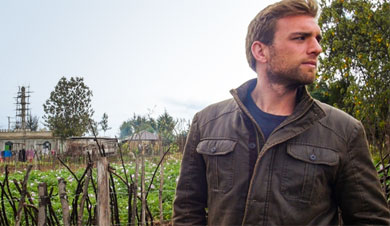 Mike Chambers contemplates his next big adventure while standing in a field.