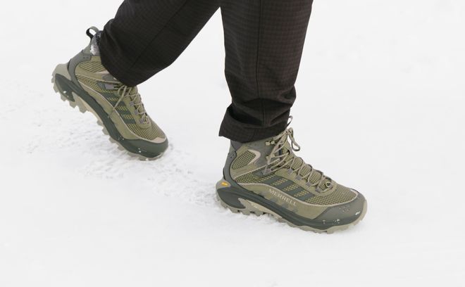 Men’s Merrell winter boots worn in the snow.