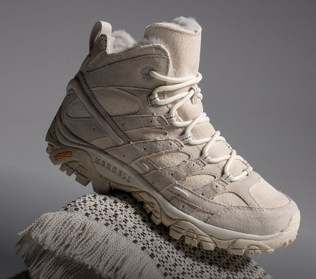 Person tying Merrell running shoes