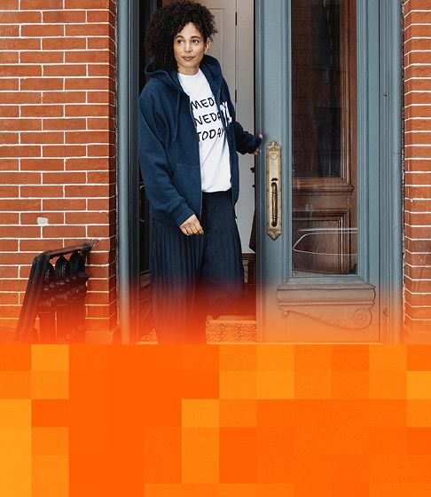Person standing in a New York City doorway.
