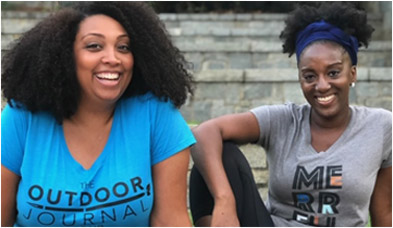 Kenya and Michele Jackson-Saulters with glowing smiles sitting on stone steps.