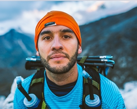 Guy with orange hat in the mountains