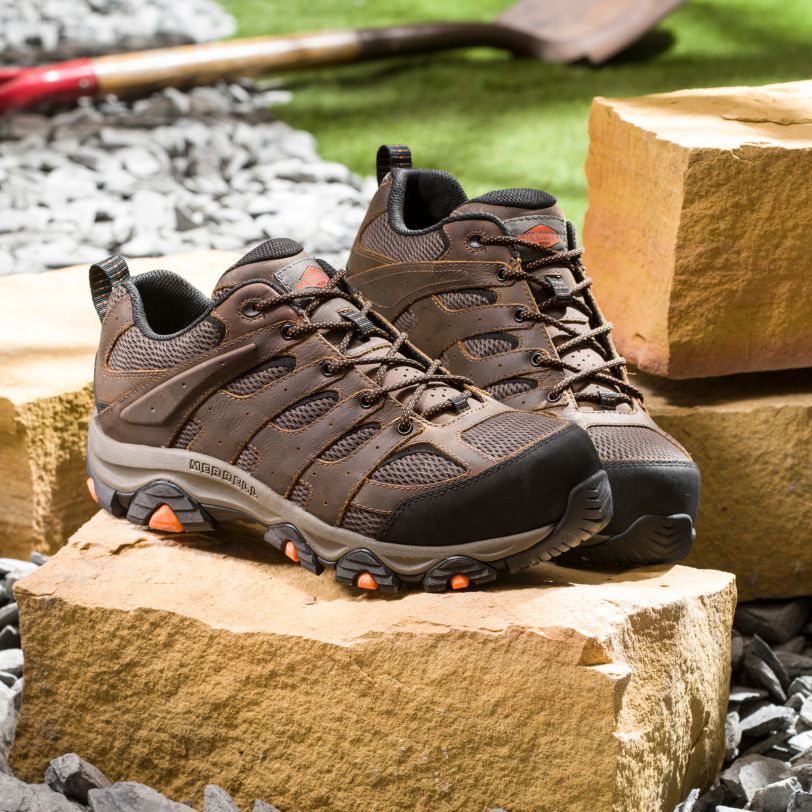a pair of brown shoes on rocks