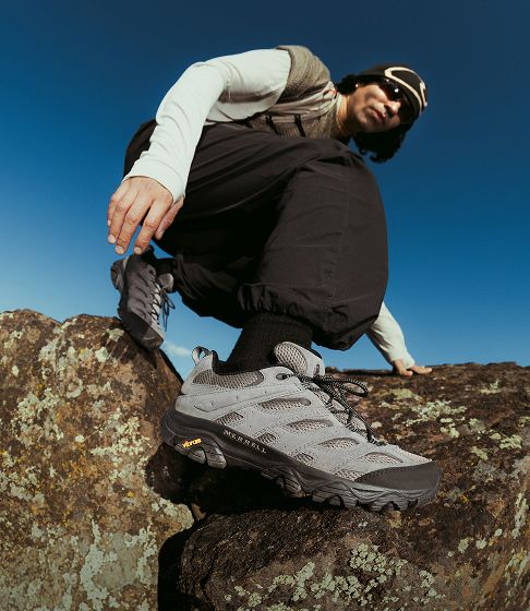 Merrell Moab hiking shoe on rocky terrain.