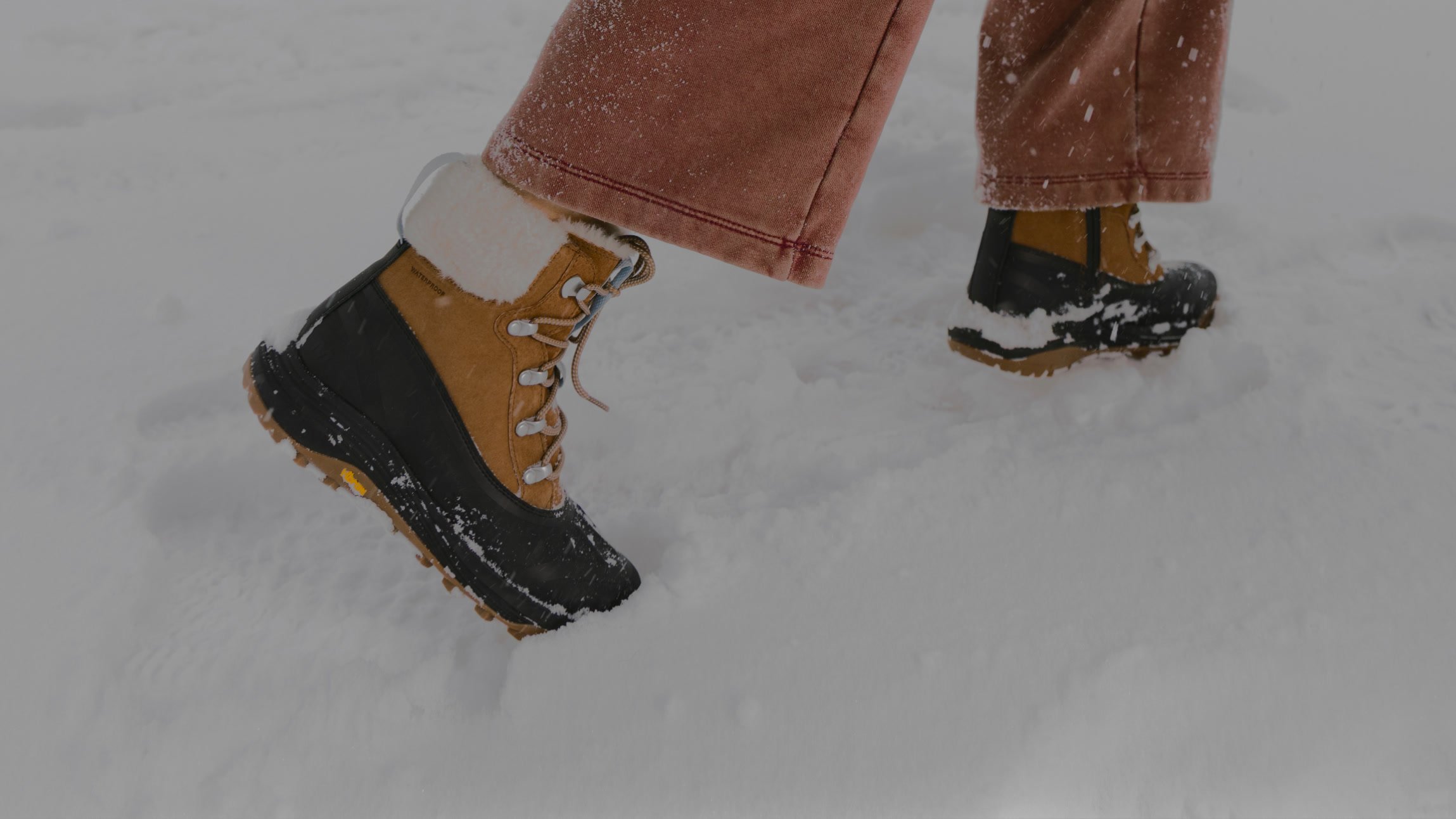 Merrell insulated winter boots walking through fresh snow