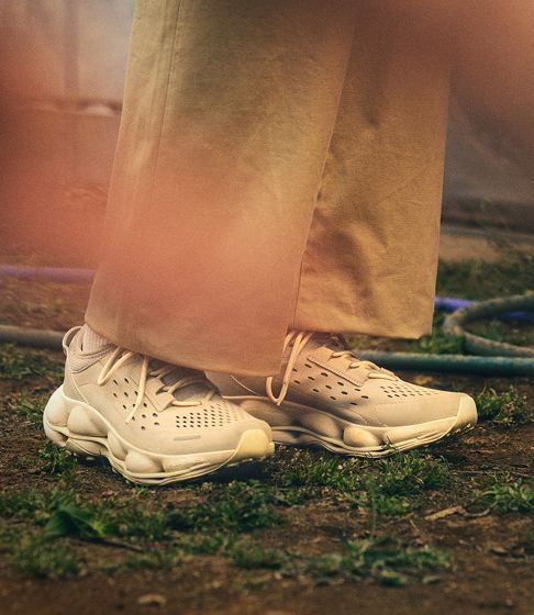 Person standing outdoors in new arrival shoes.
