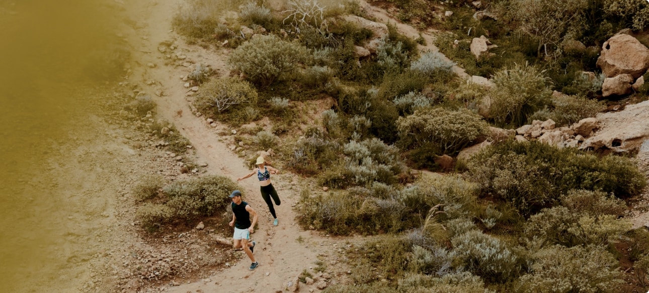 People running down a dirt trail.