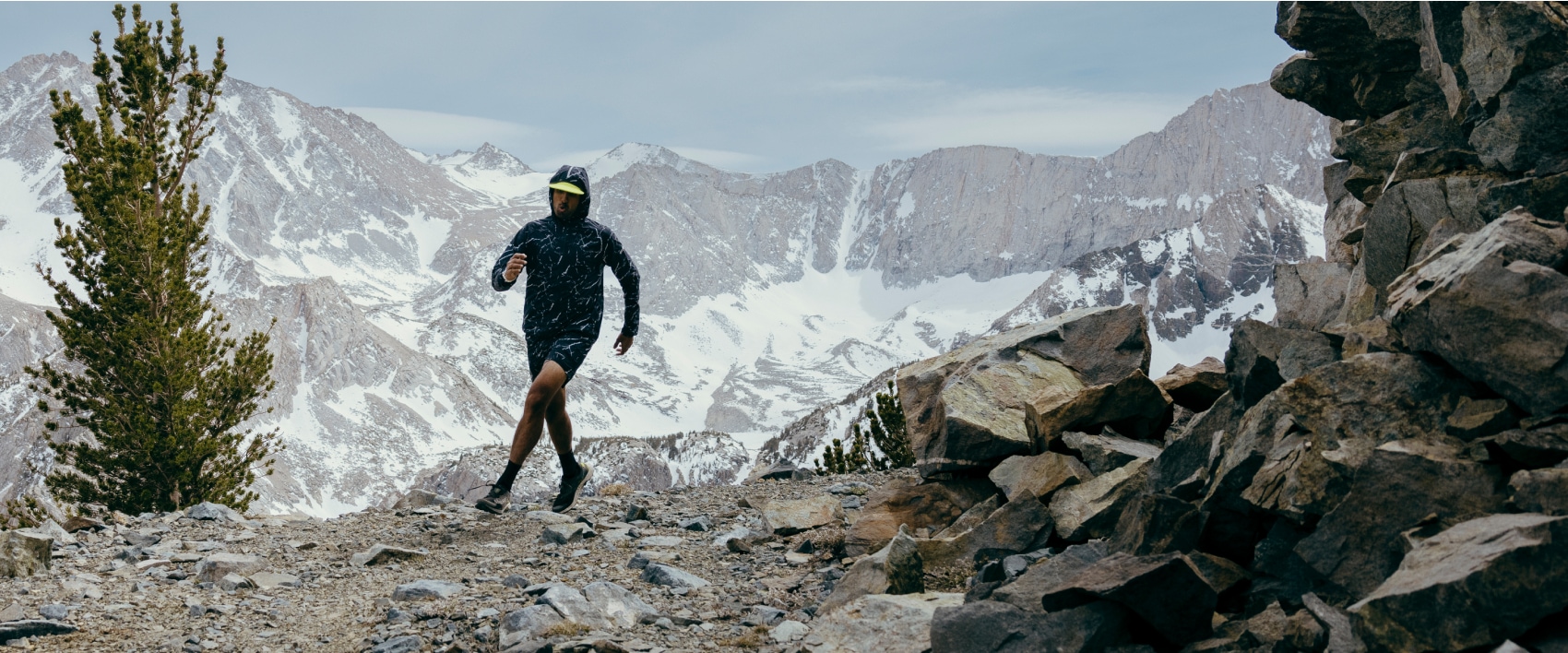 Aum running through the cold mountains wearing Merrell gear, looking fast.