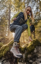 Person's feet in Merrell shoes, running outside.