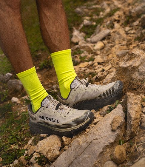 Person running in merrell shoes outside.