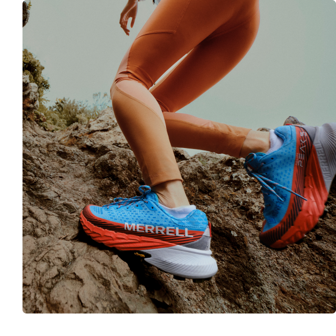 Person running a hiking trail in a pair of Agility Peak 5s.