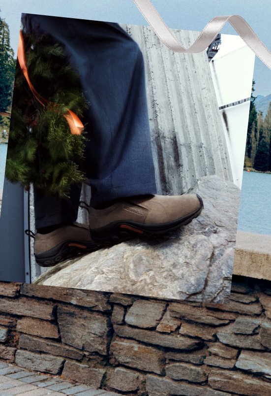 Person wearing Merrell winter slip-ons outdoors in the snow.