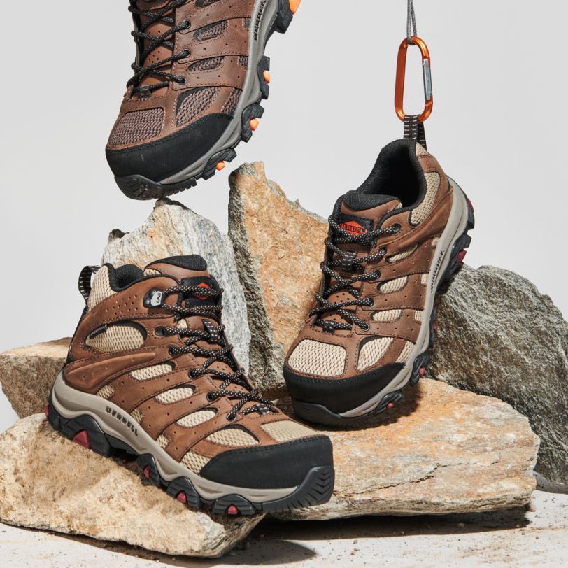 a pair of hiking shoes on rocks