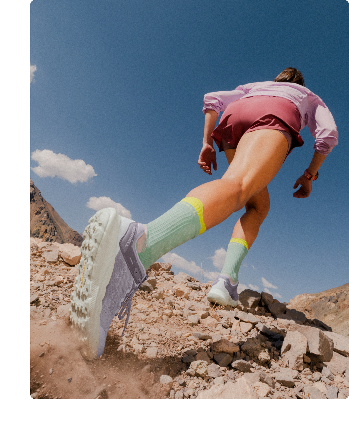 Person running a hiking trail in a pair of Antora 4s.