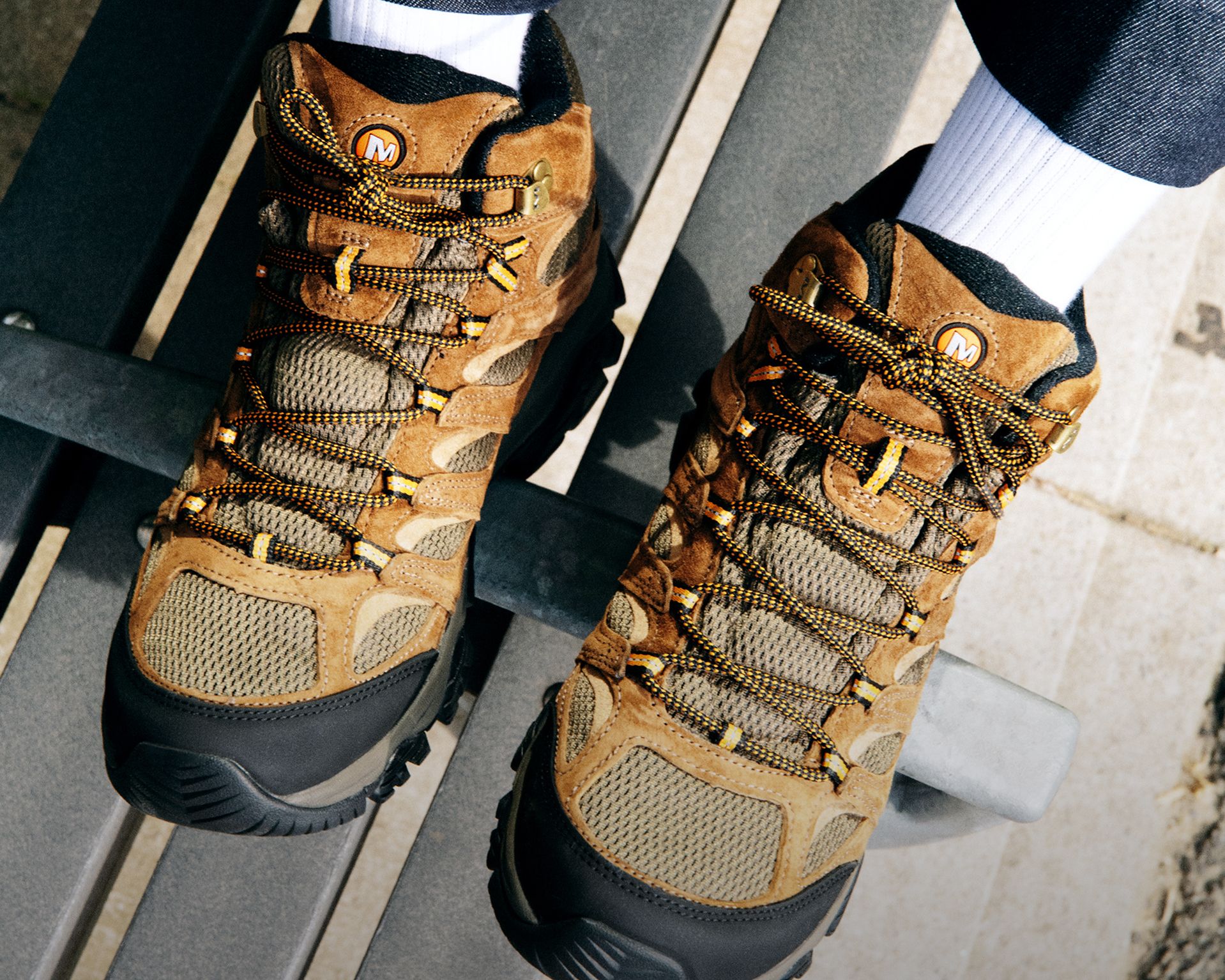 Person wearing Merrell boot on a snowy trail.