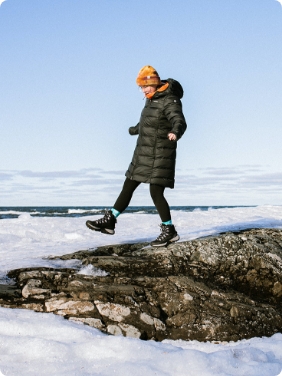 Woman hiking outside in the snow