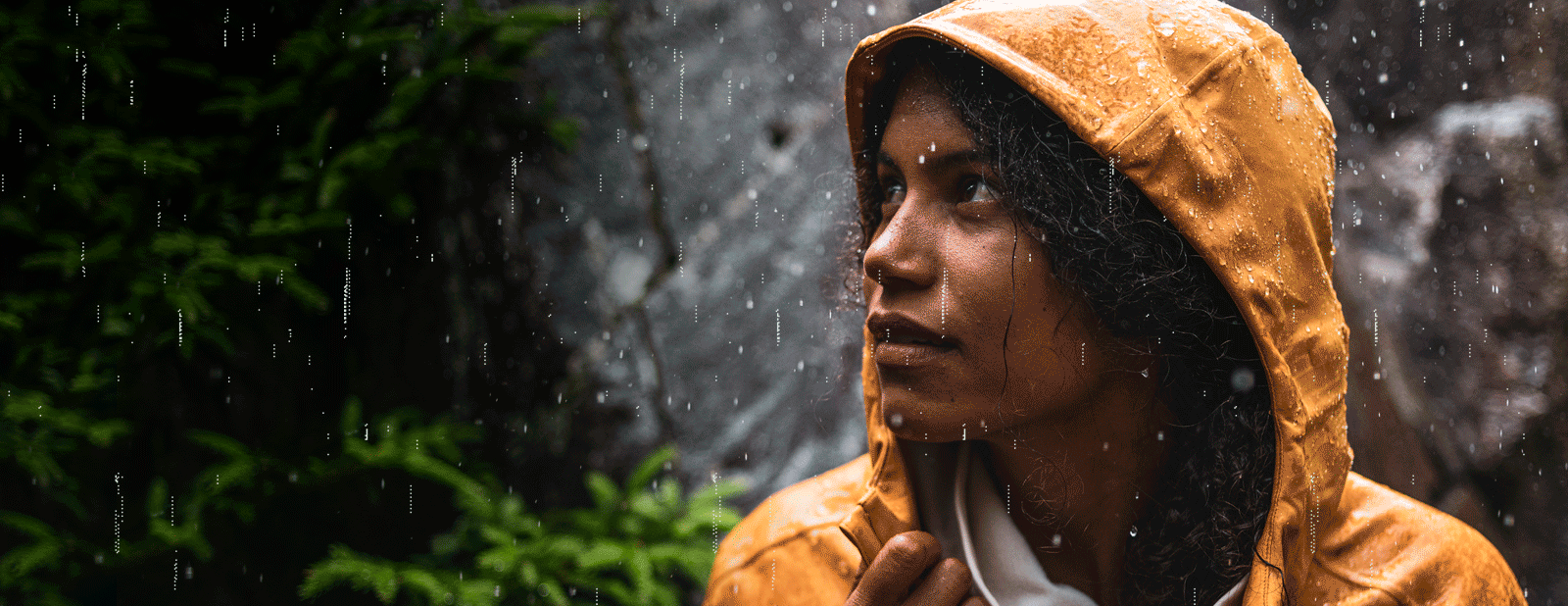 Women standing in the rain wearhign a Whisper Rain Jacket