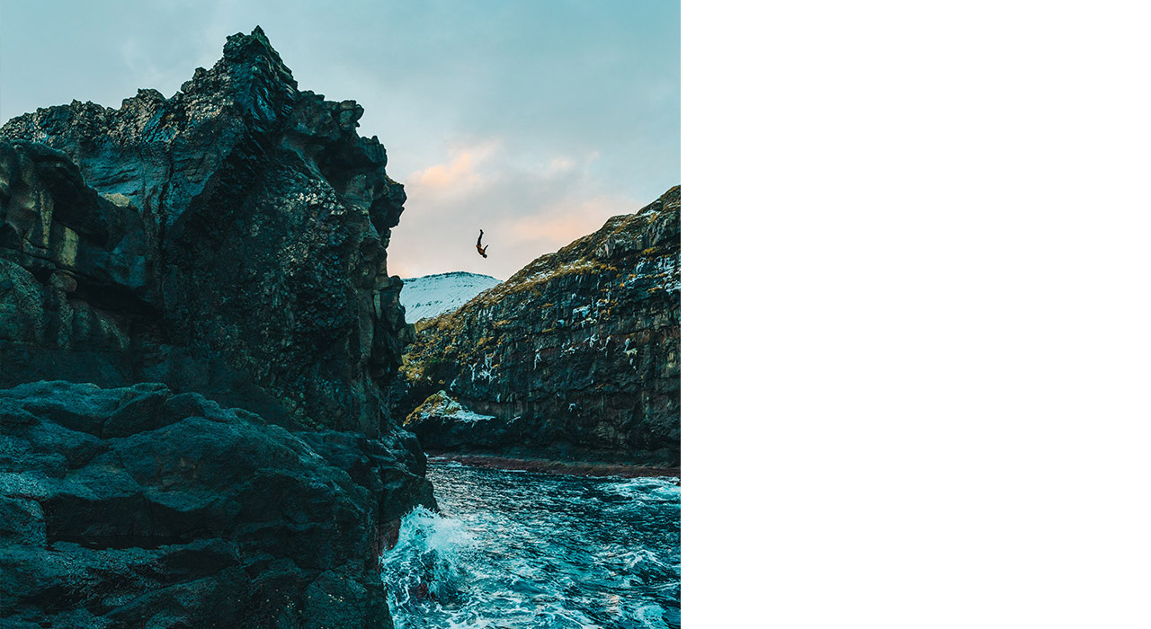 3 friends hiking up on a rock outcrop