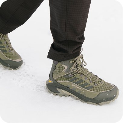 Man walking through snow wearing Merrell waterproof winter boots