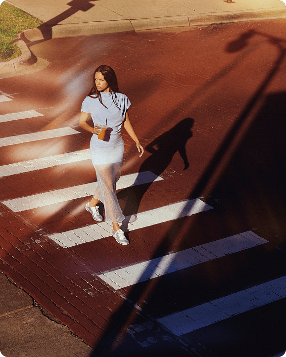 A person walking accross the street.