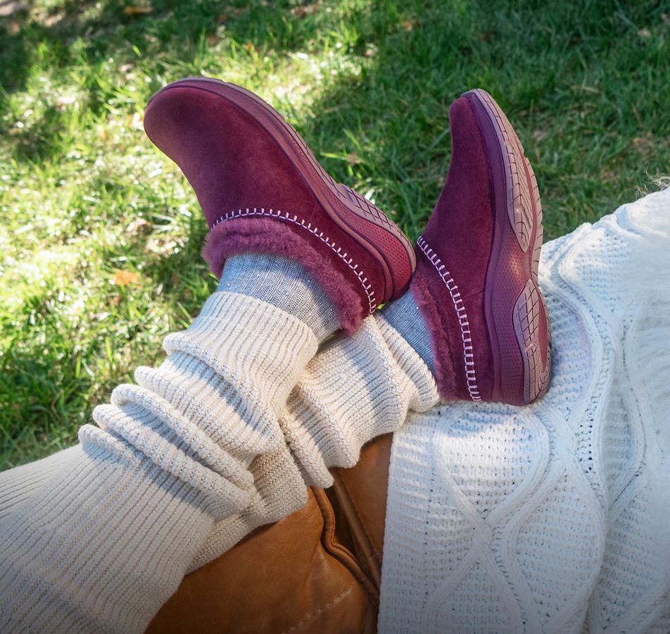 Person tying Merrell running shoes
