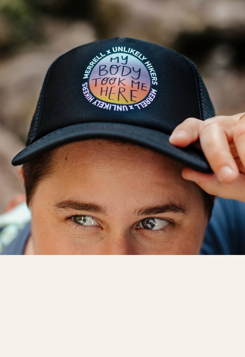 bright-eyed person peering out from under the brim of a stylish baseball cap.