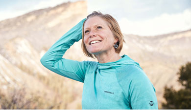 Anna Frost excitedly smiling in anticiaption to her trail run.