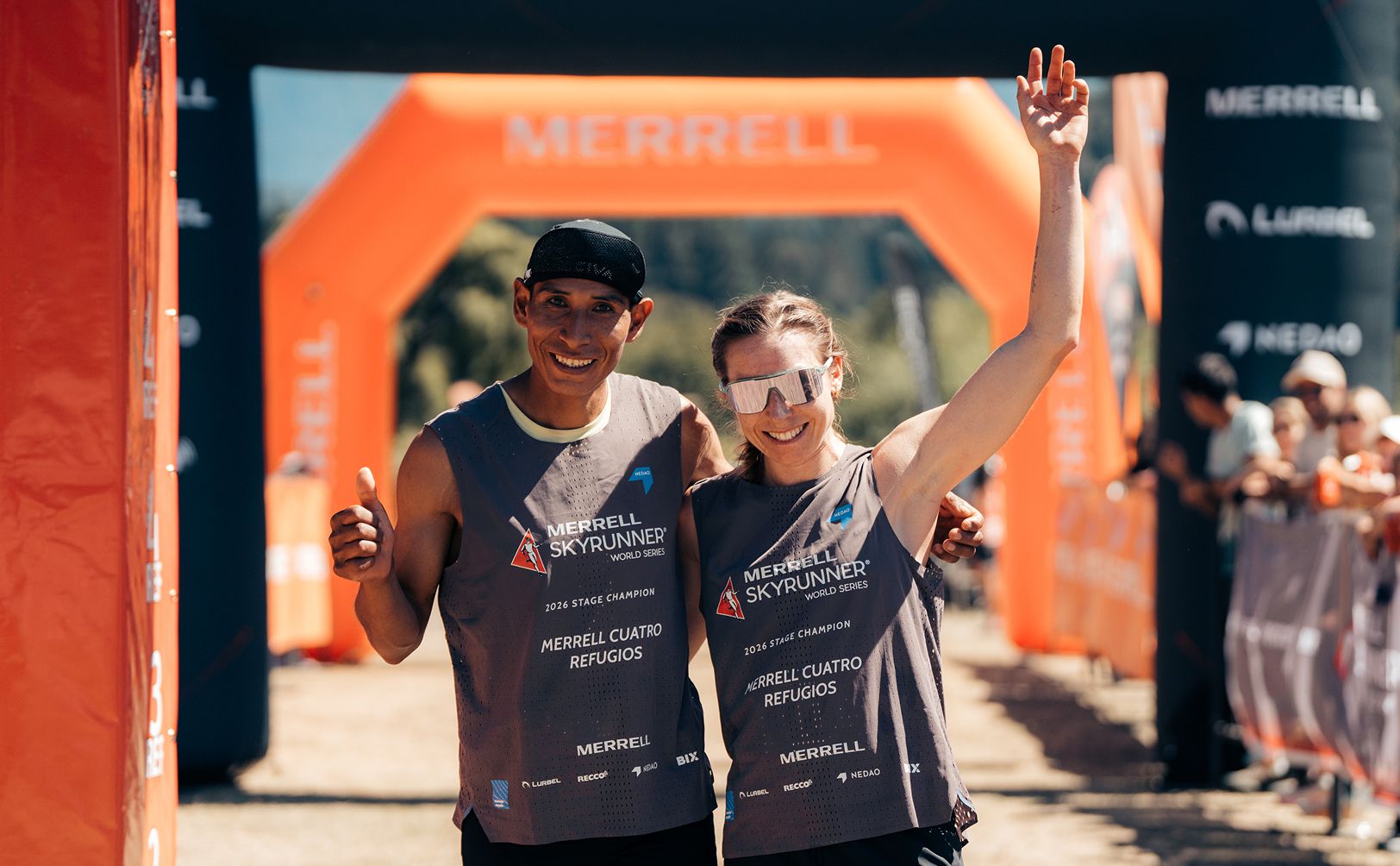 People posing for a picture at the finish line of a race.