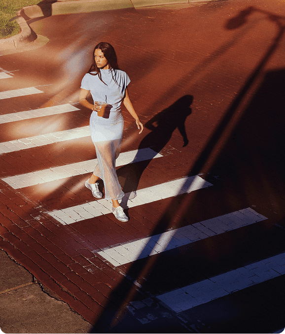 A person walking accross the street.
