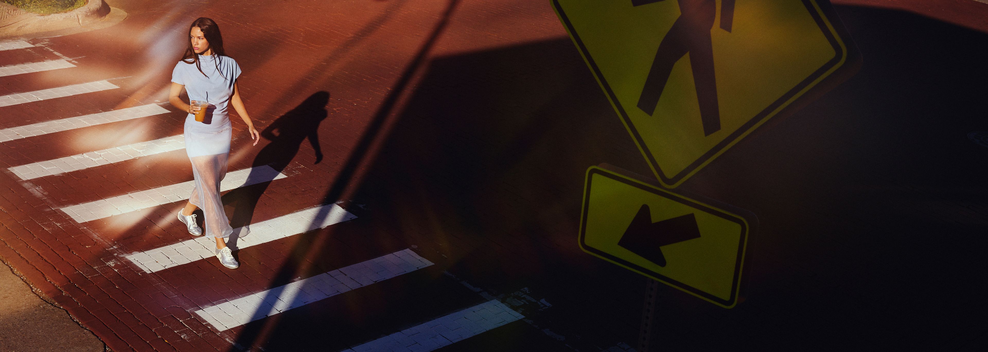 A person walking accross the street.