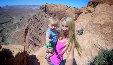 Brooke Froelich bravely holding her infant just feet away from the edge of a 200 foot canyon wall.