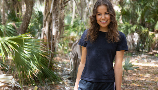 Manuela Baron smiling in a jungle.