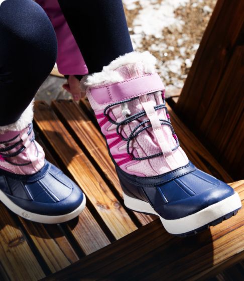 Kids in the snow wearing Merrell winter boots