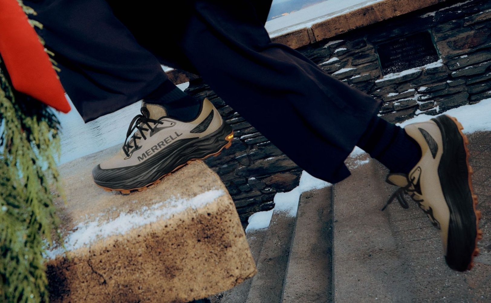 Merrell trail running shoes stepping up stone stairs.