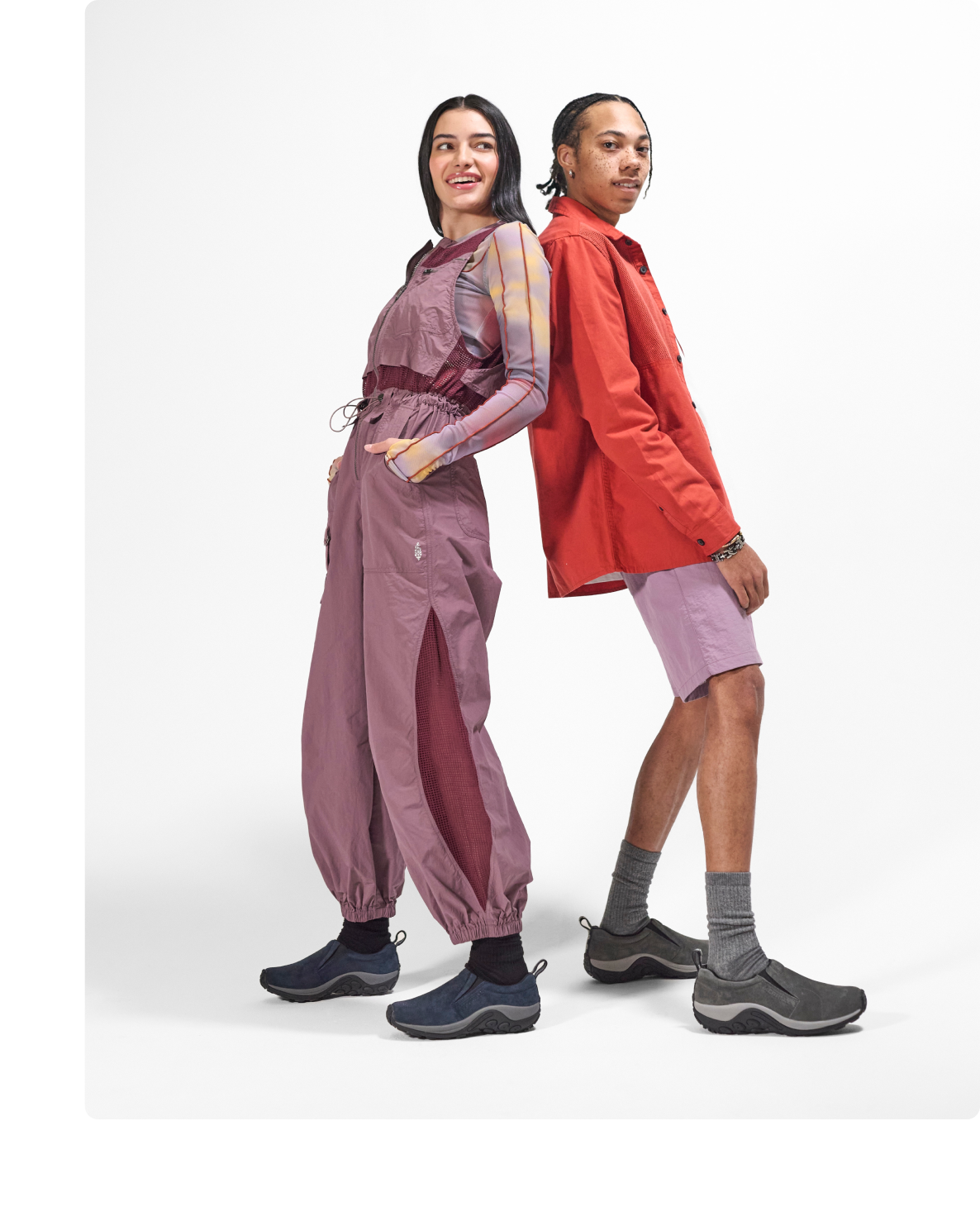Two people standing back to back wearing jungle moc's.