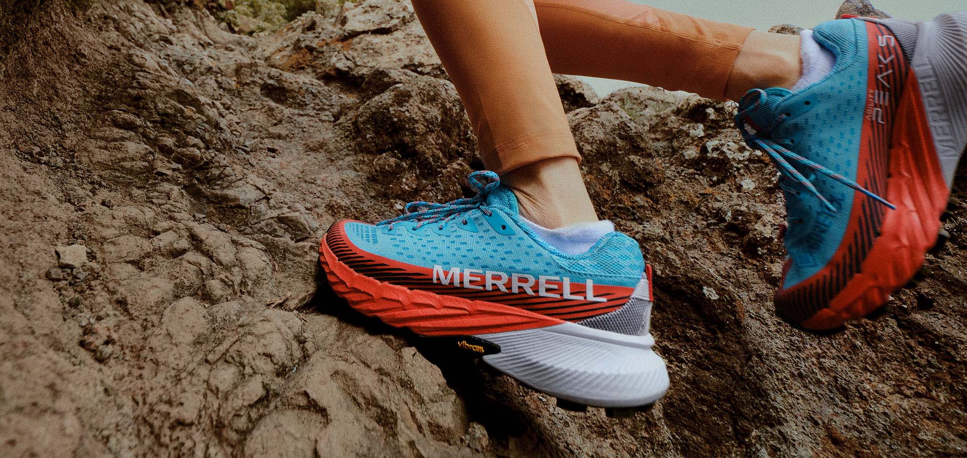 Woman running up a hill in Merrell's