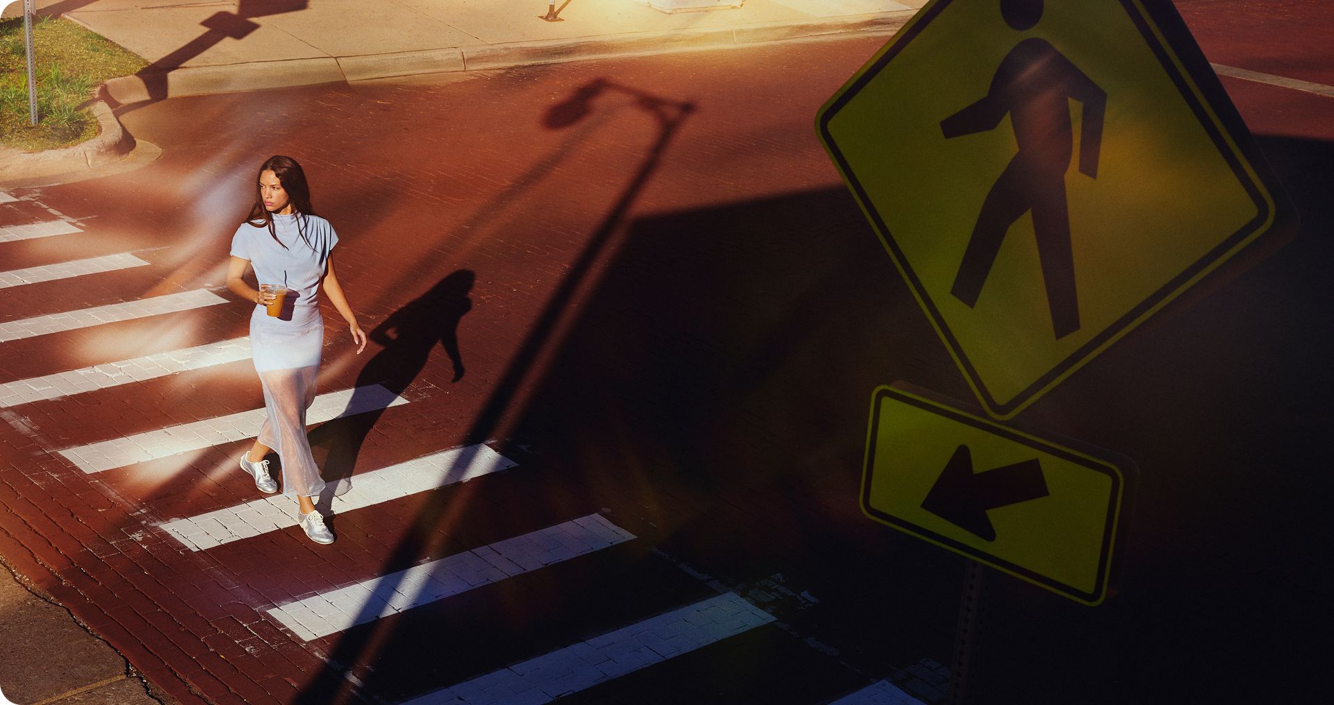 A person crossing the street wearing Merrell Relay shoes.