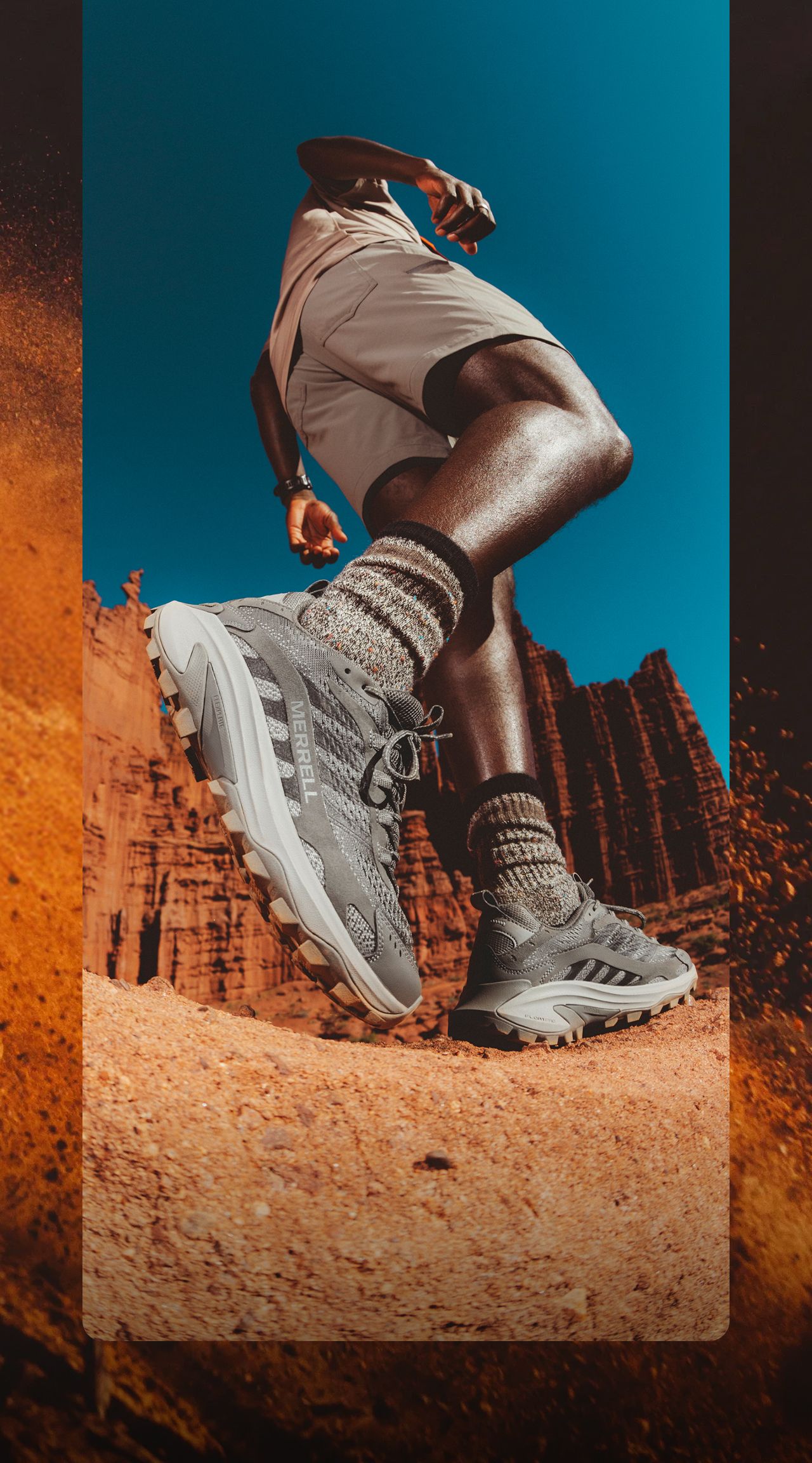 Person hiking outside in red rock canyons wearing Merrell shoes
