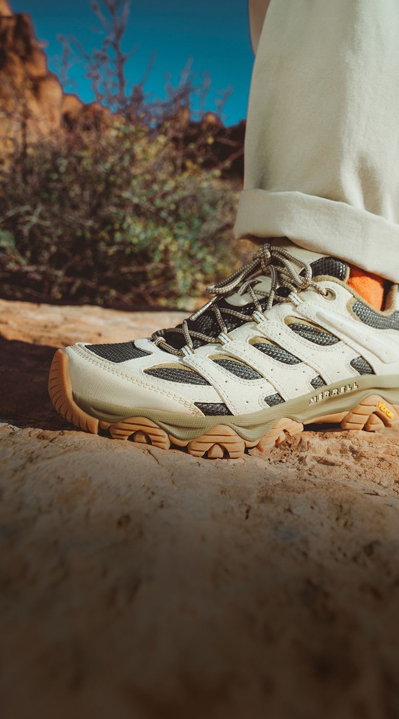Person hiking outside near a creek wearing Merrell shoes