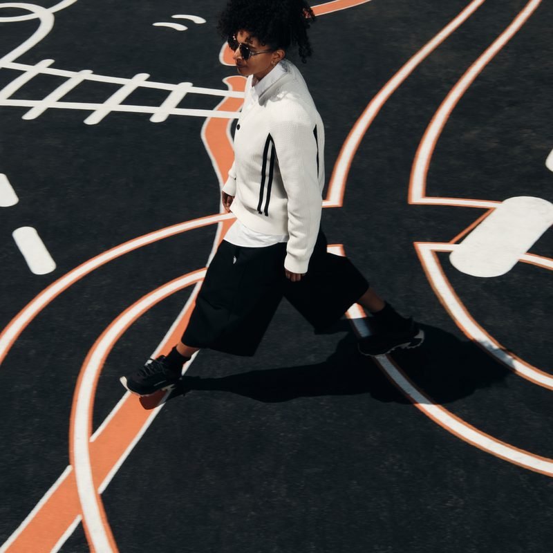 Shantell Martin stepping back to look at her finished mural