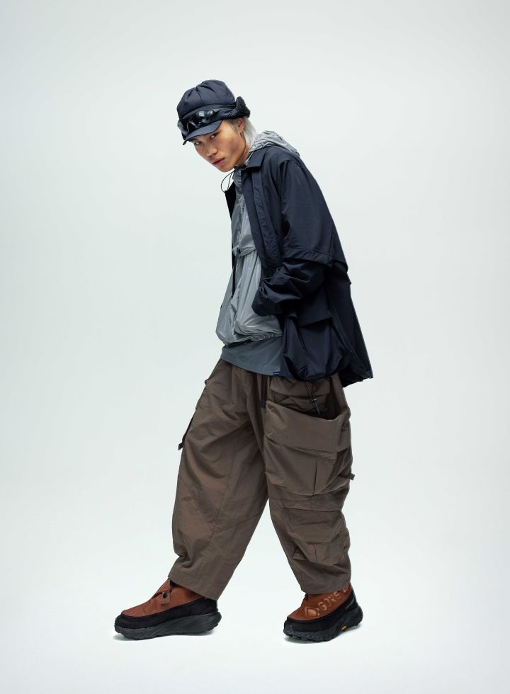 Model in colorful outfit with black boots