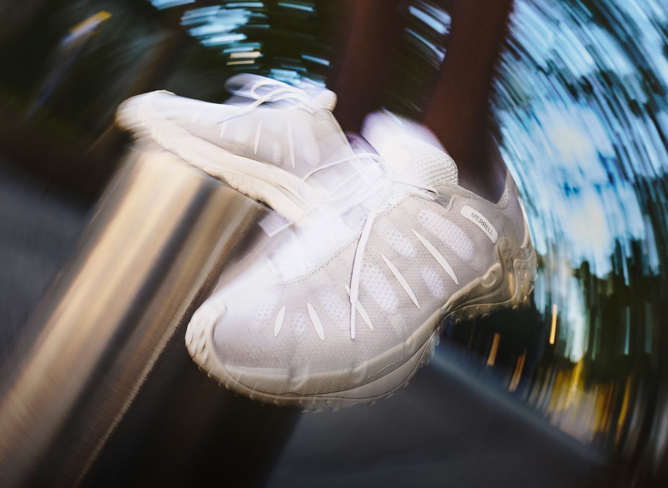 Person wearing casual Merrell shoes outside.