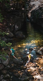 Two people out for a hike, crossing a creek..